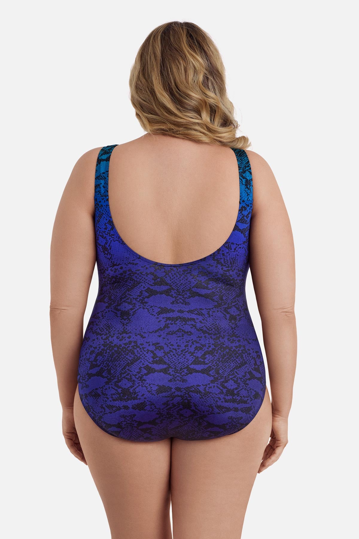 Woman turned away wearing a blue ombre animal-esque printed one-piece swimsuit