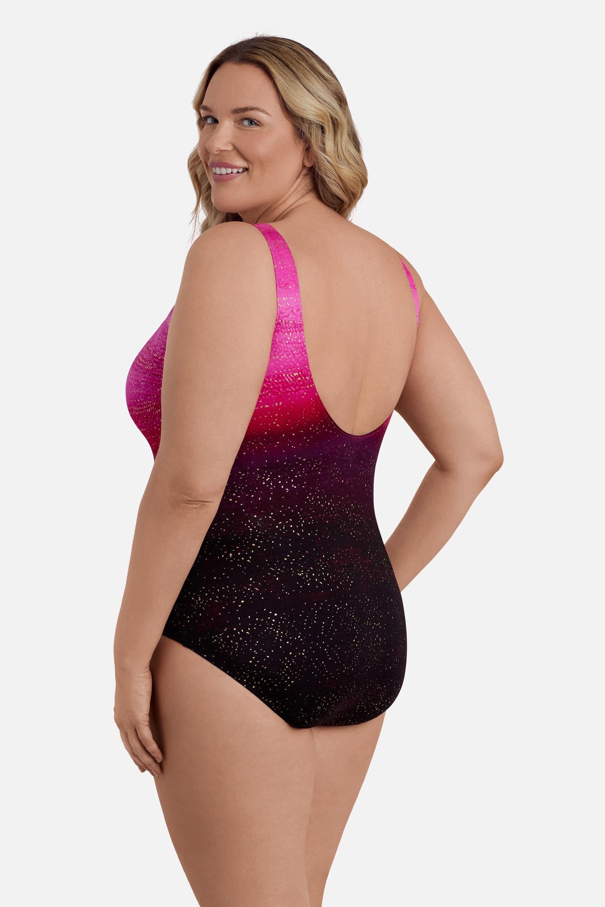 Woman turned left wearing a pink ombre one-piece swimsuit with shimmer detail