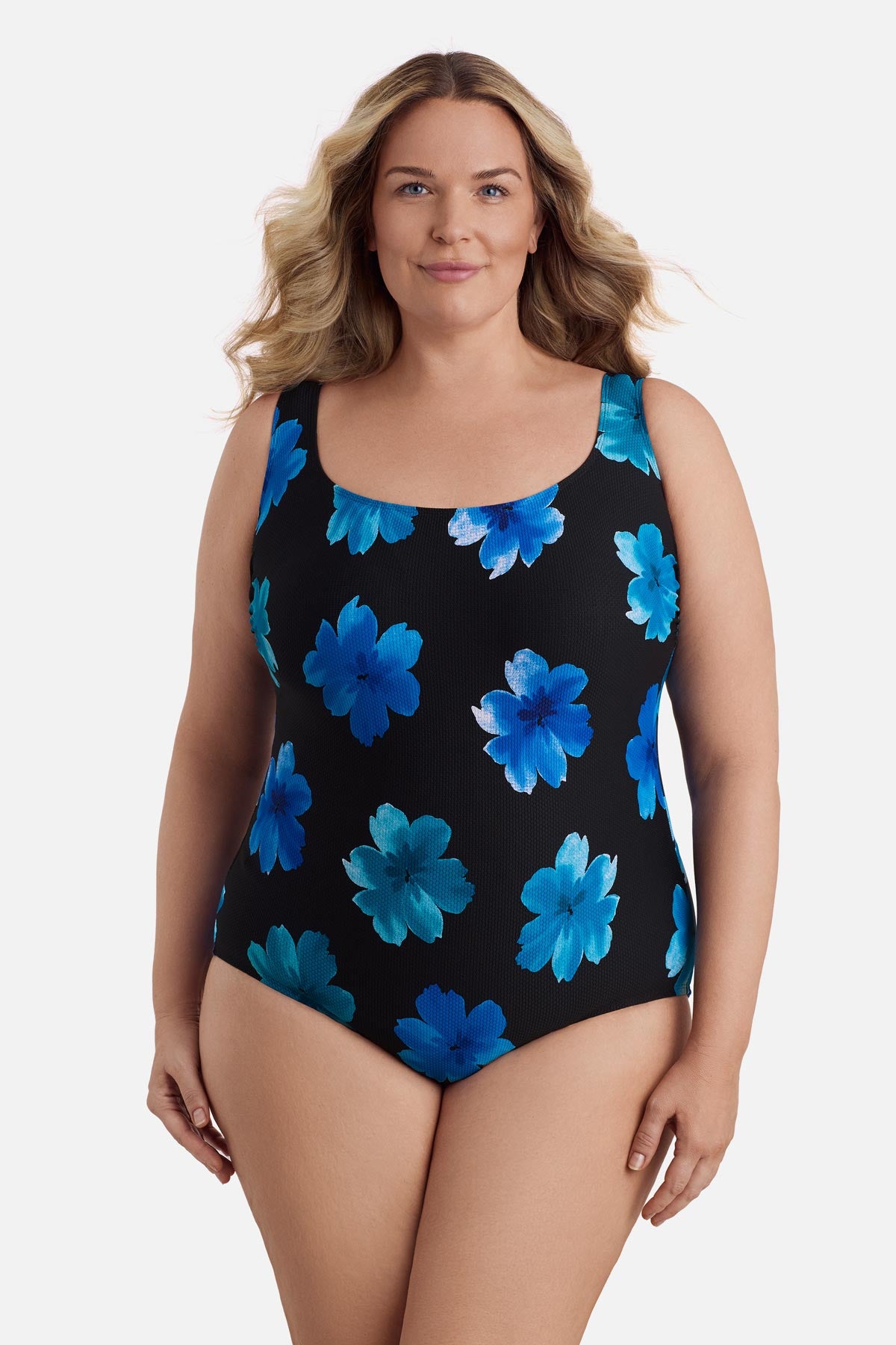 Woman wearing a large blue flower printed one-piece swimsuit