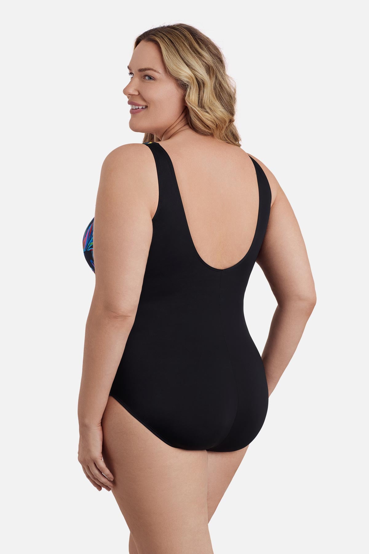Woman turned left wearing a multicolored abstract printed one-piece swimsuit