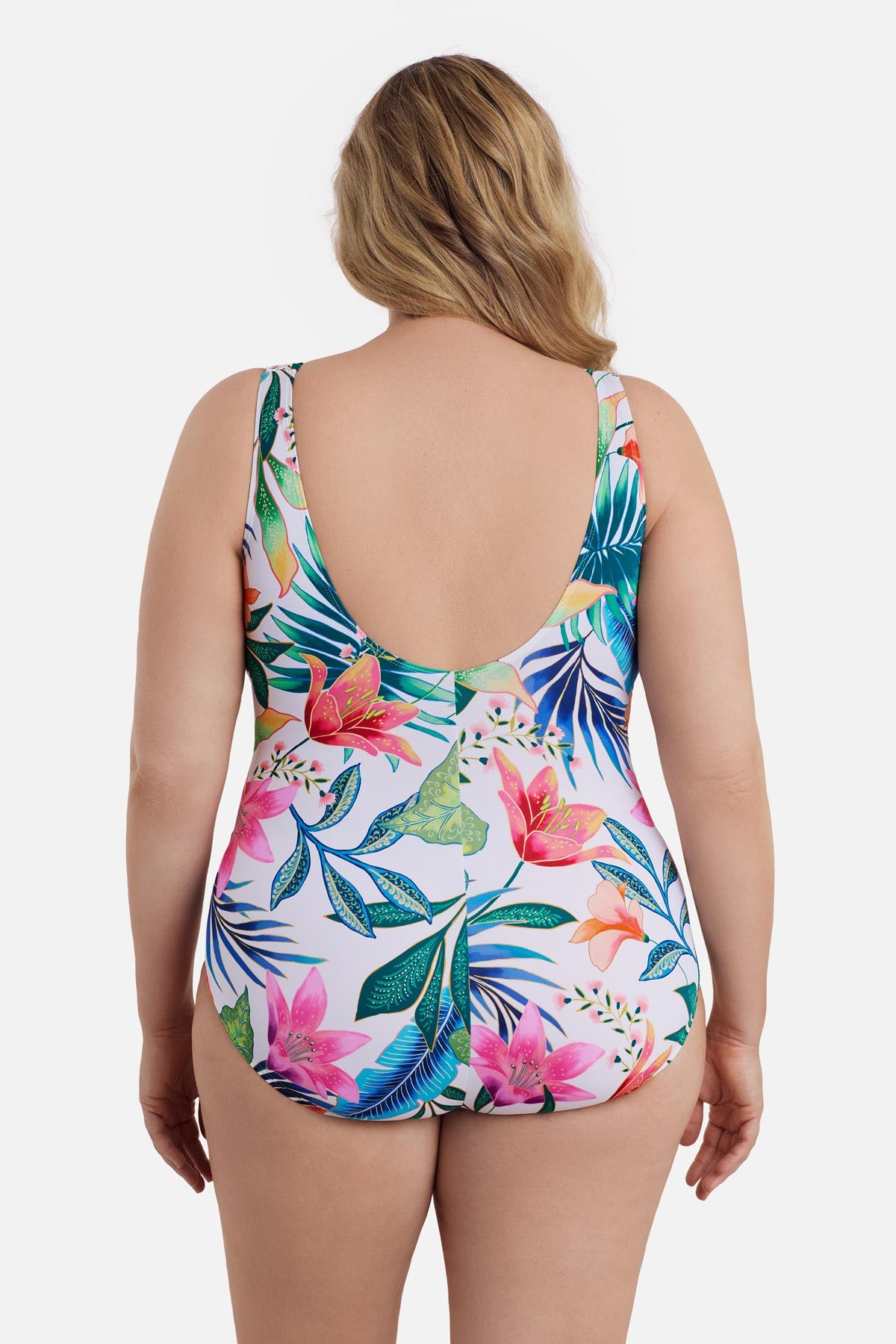 Woman turned away wearing a multicolored floral printed one-piece swimsuit