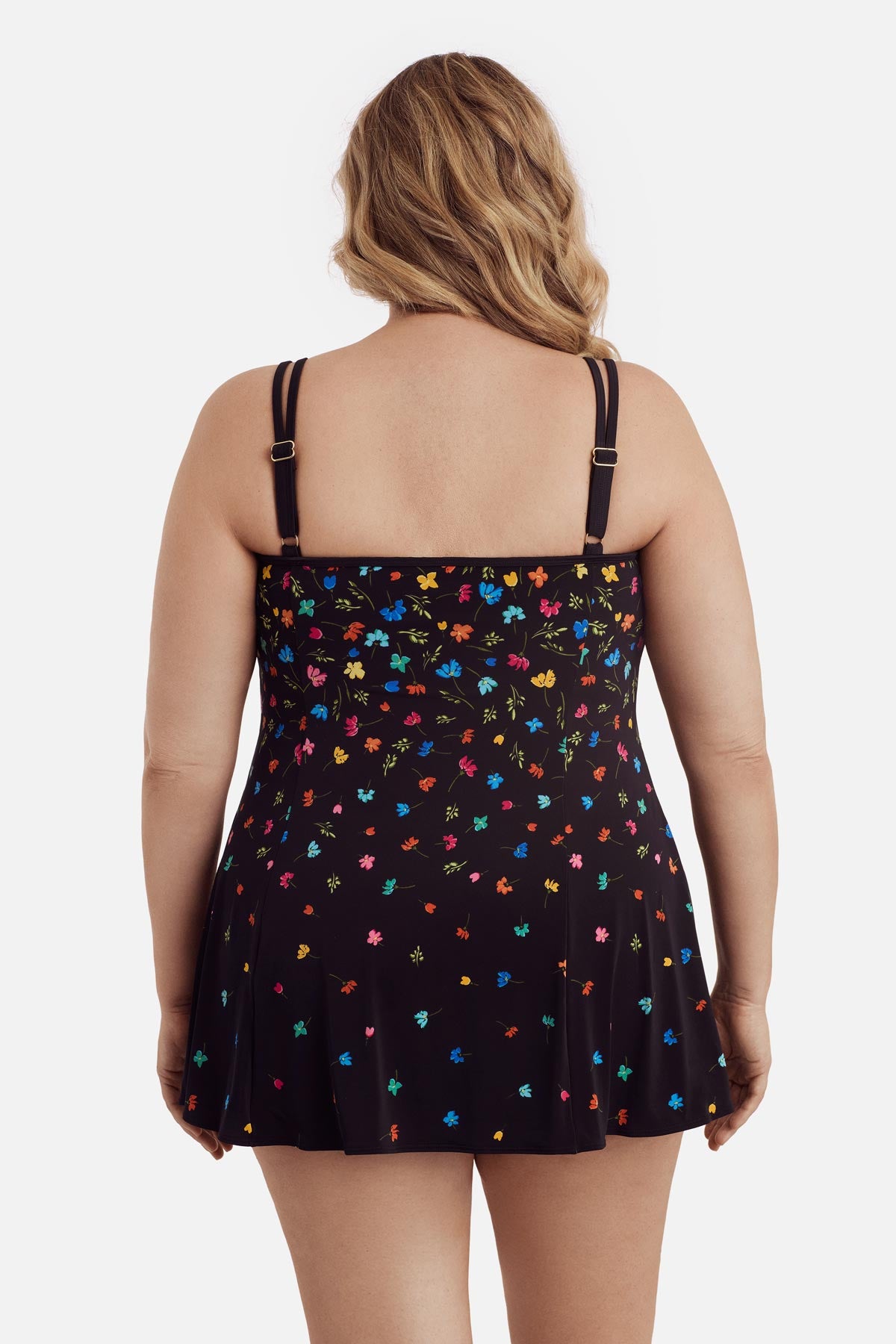 Woman turned away wearing a multicolored floral printed swim dress