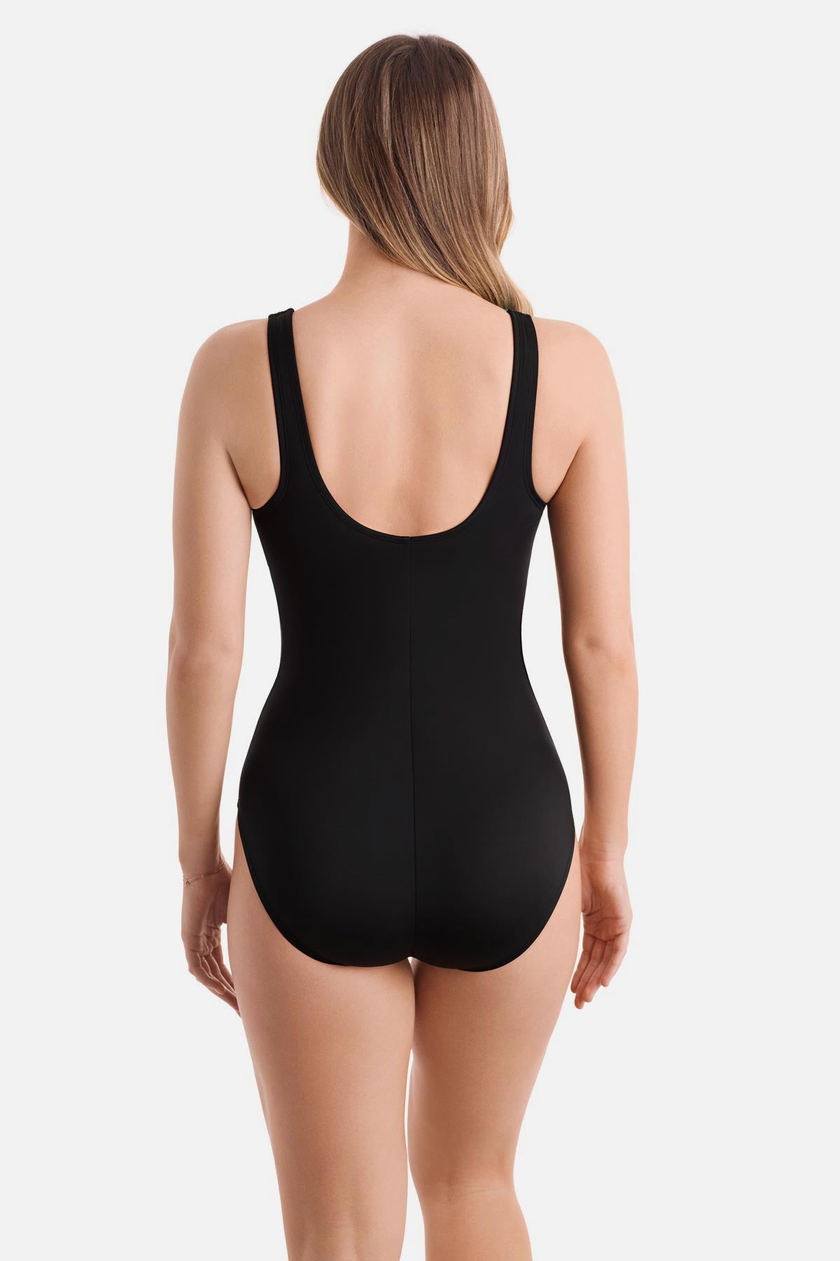 Woman turned away wearing a black one-piece swimsuit