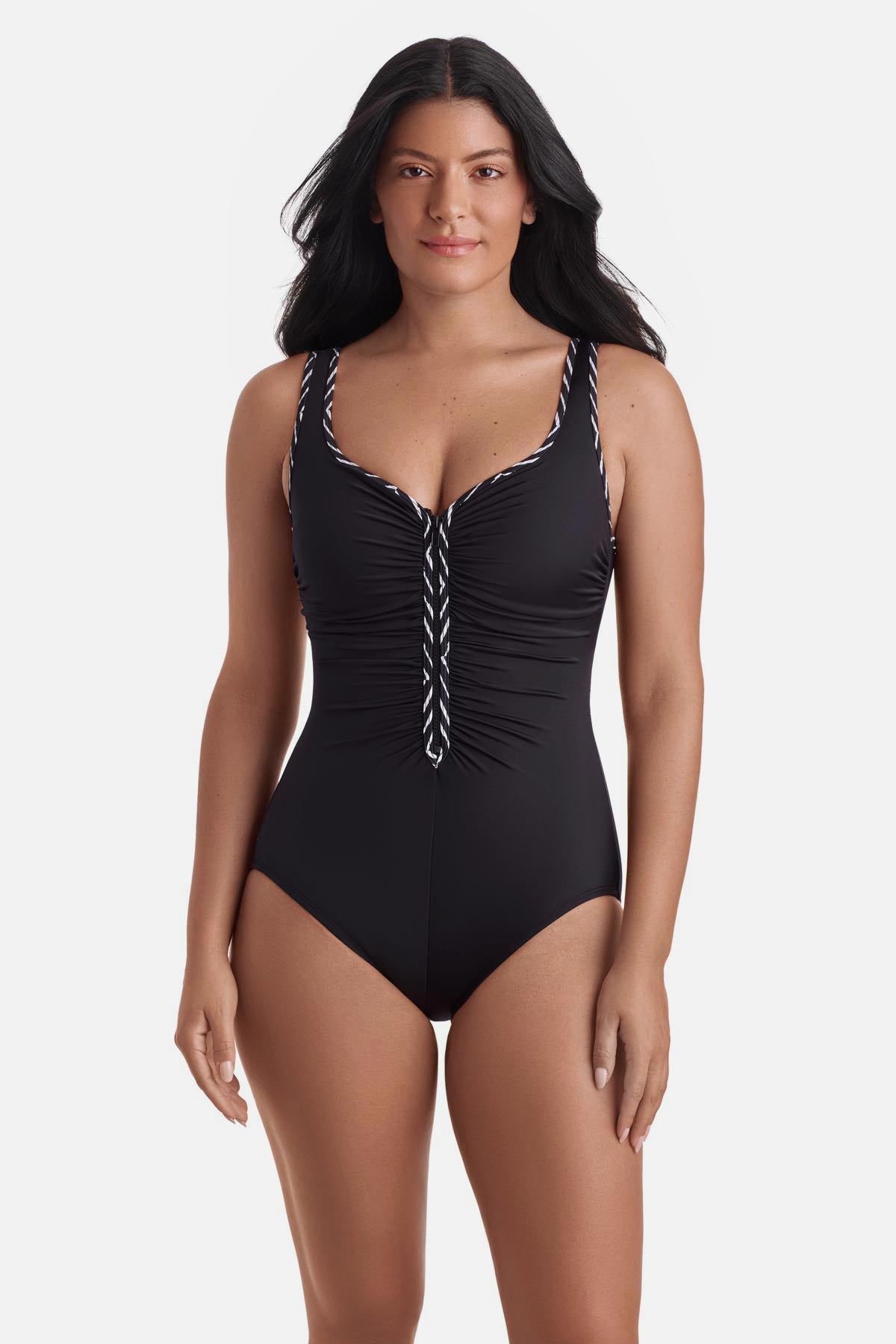 Woman wearing a black one-piece swimsuit with black and white piping on the edges