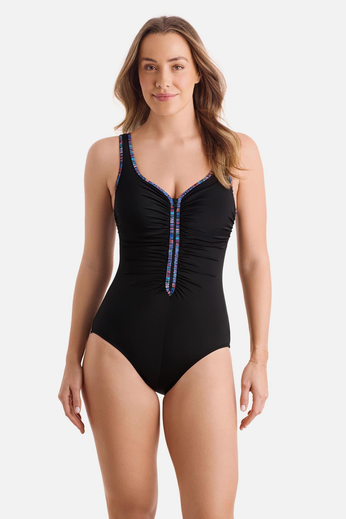 Woman wearing a black one-piece swimsuit with rainbow piping