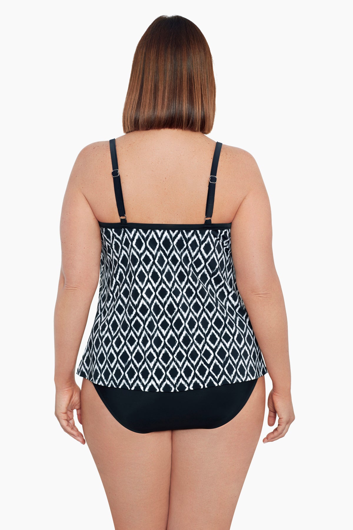 Woman turned away wearing a black and white diamond pattern middle split tankini