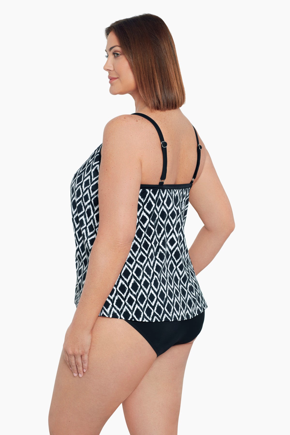 Woman turned left wearing a black and white diamond pattern middle split tankini