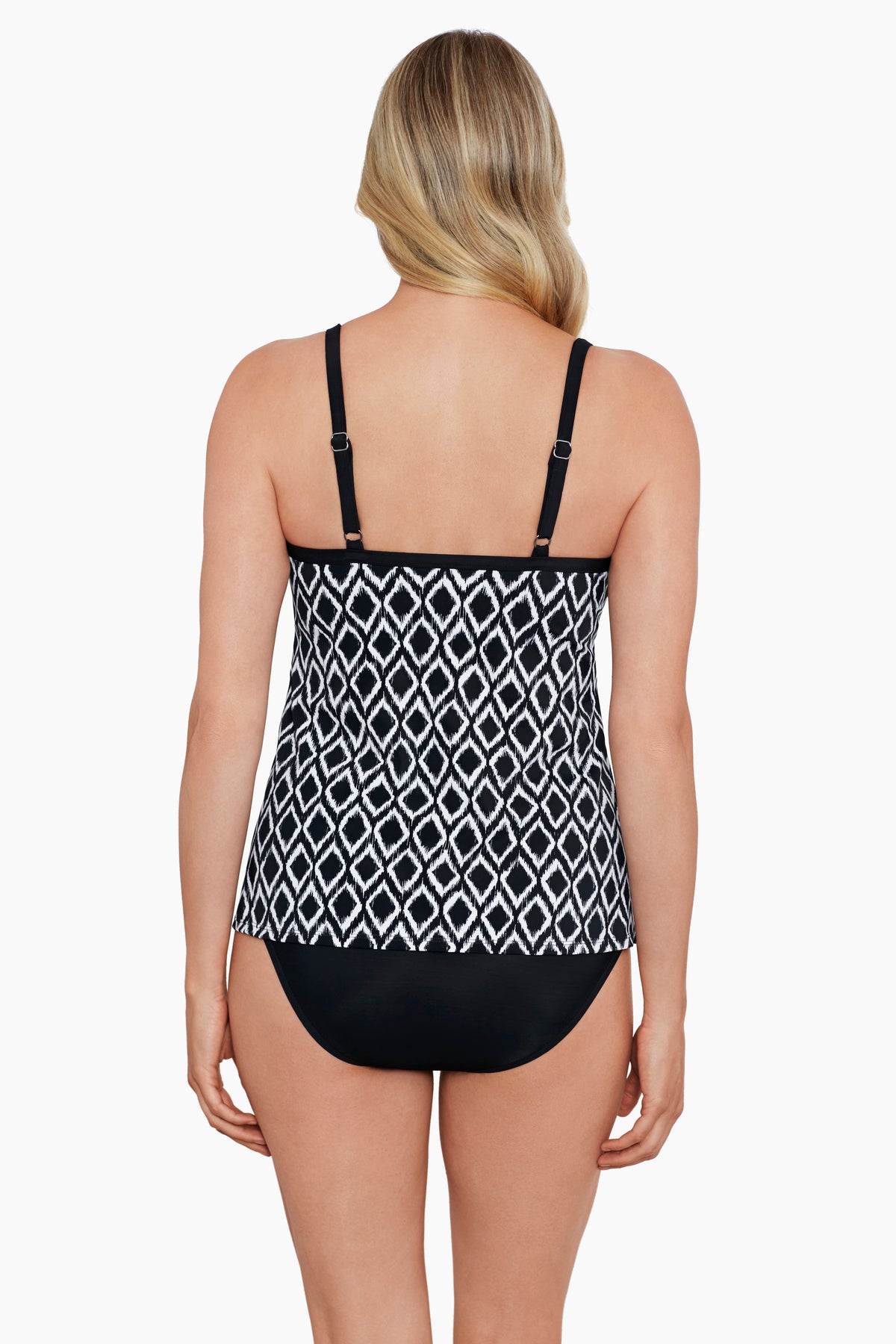 Woman faced away wearing a black and white diamond printed cut away tankini top