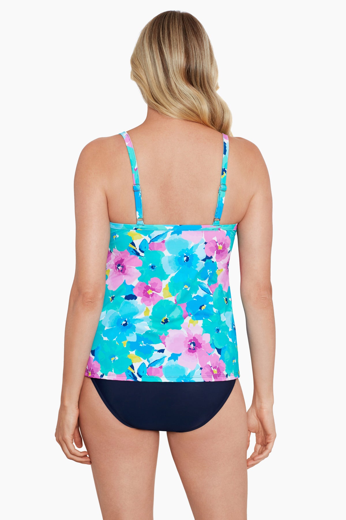 Woman turned away wearing a blue and pink floral printed cut away tankini top