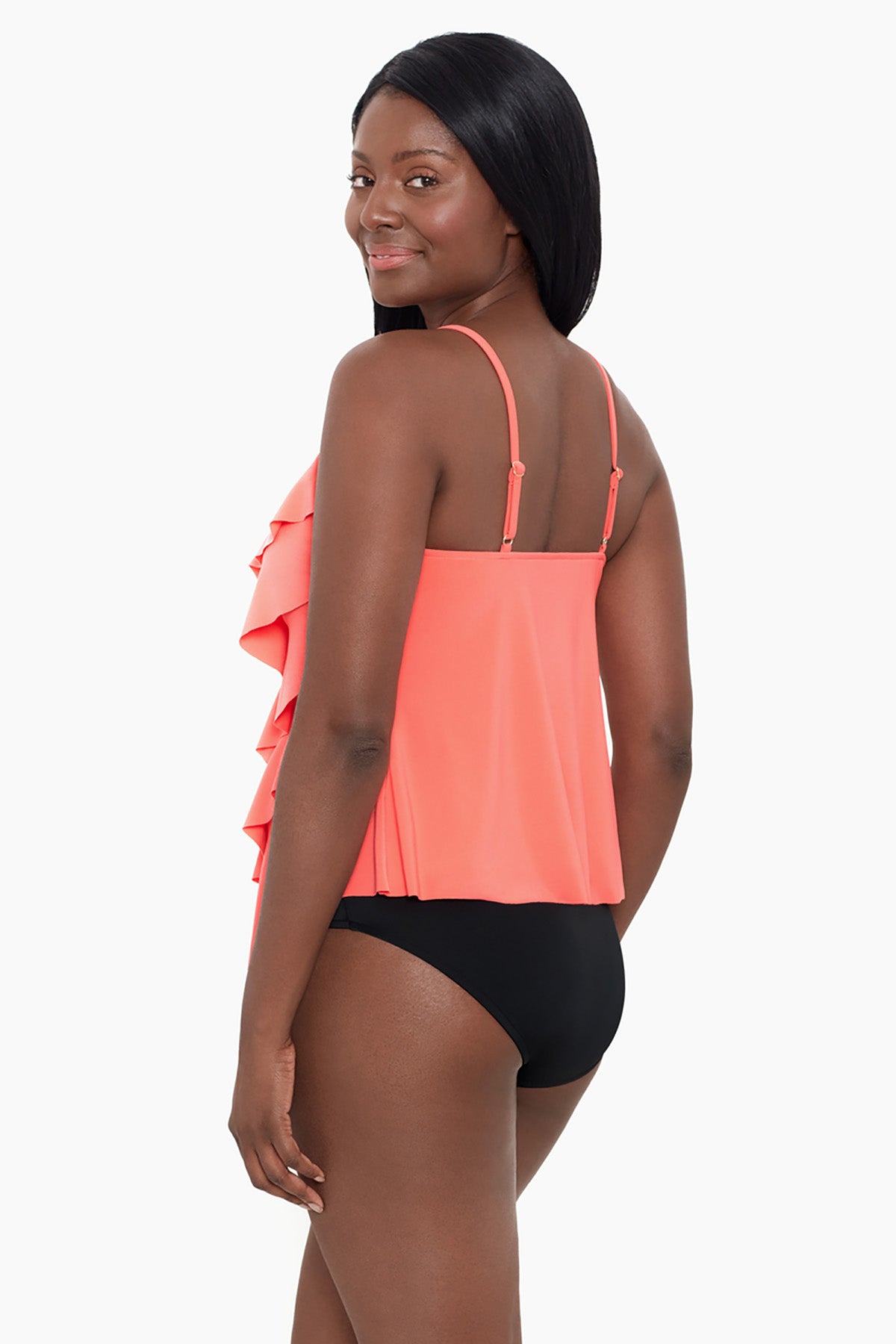 Woman turned left wearing a coral-colored ruffle tankini top