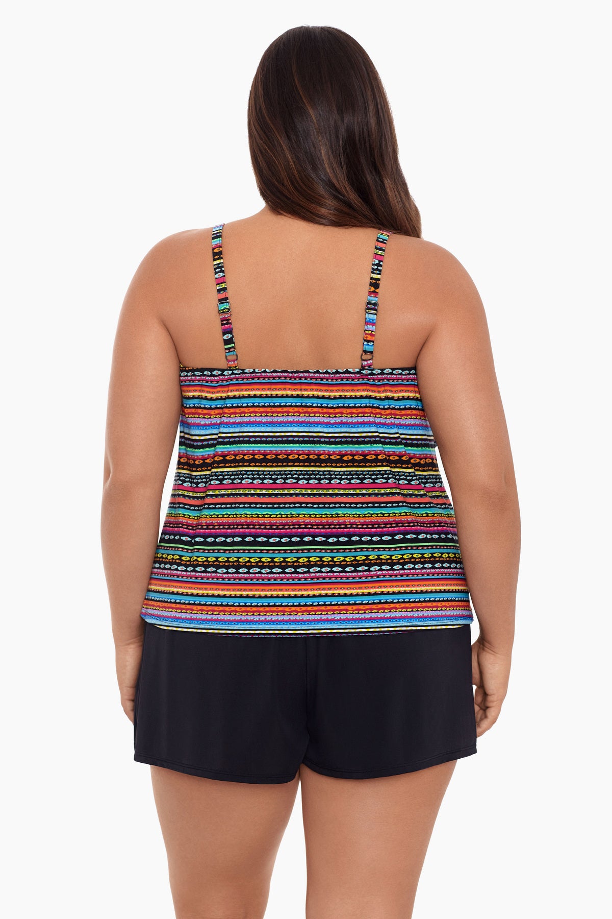 Woman faced away wearing a rainbow stripe and dash pattern swim romper