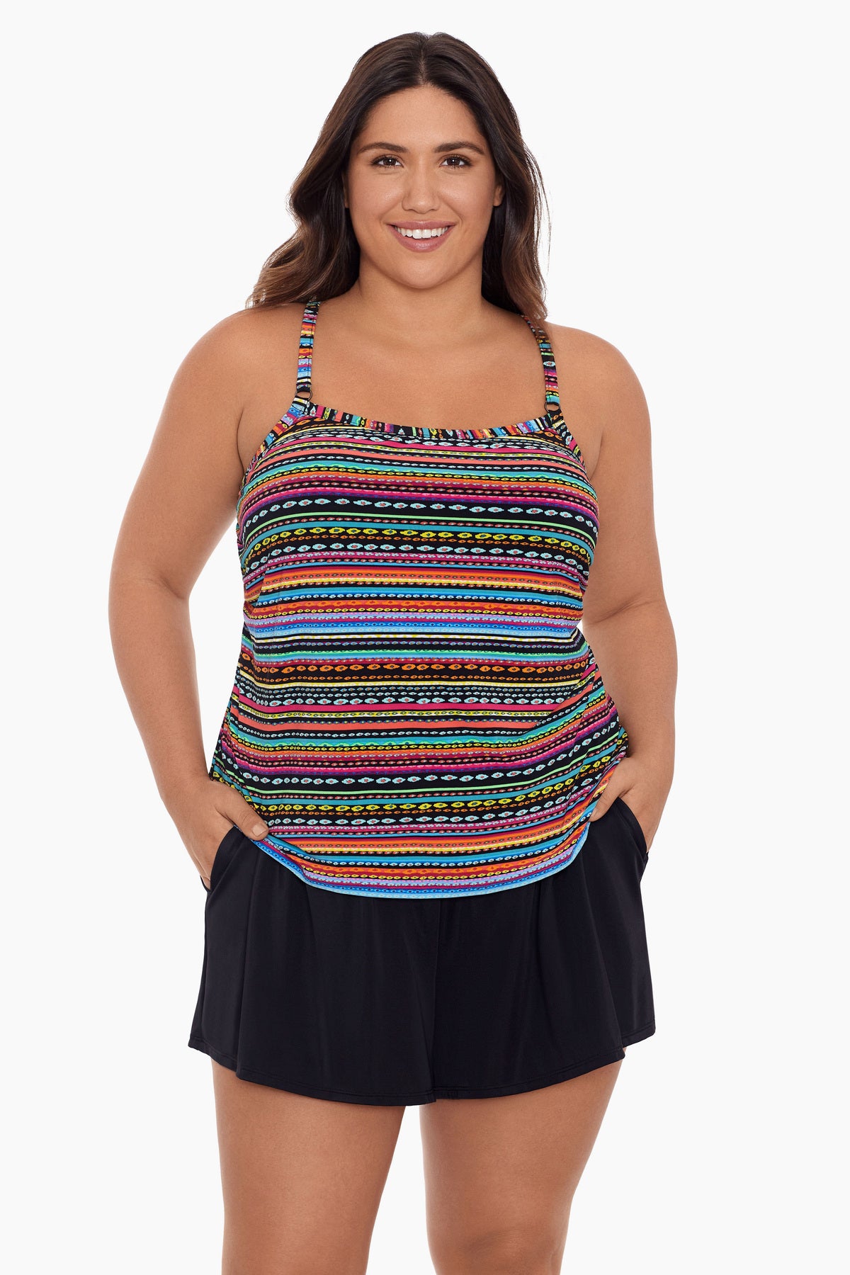 Woman wearing a rainbow stripe and dash pattern swim romper