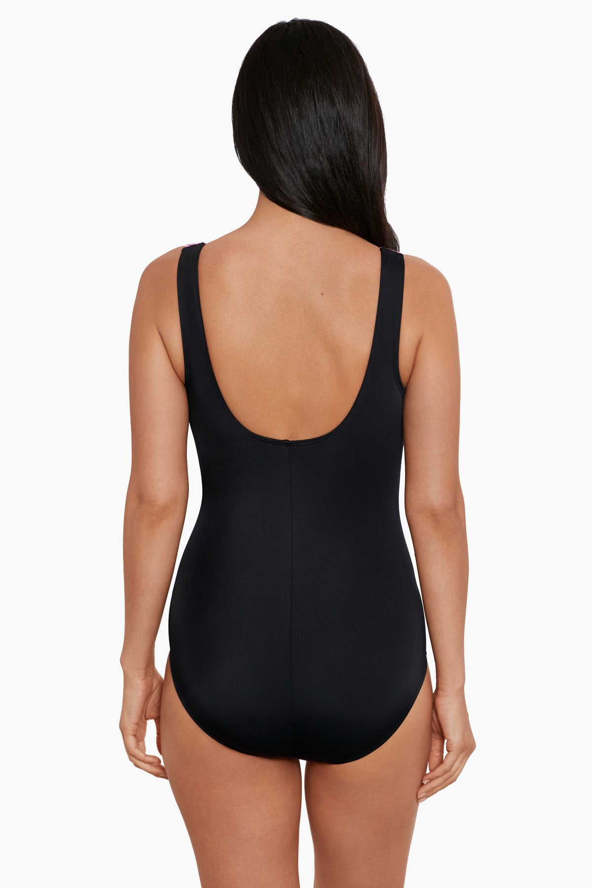 Woman faced away wearing a pink ombre zig zag pattern one-piece swimsuit