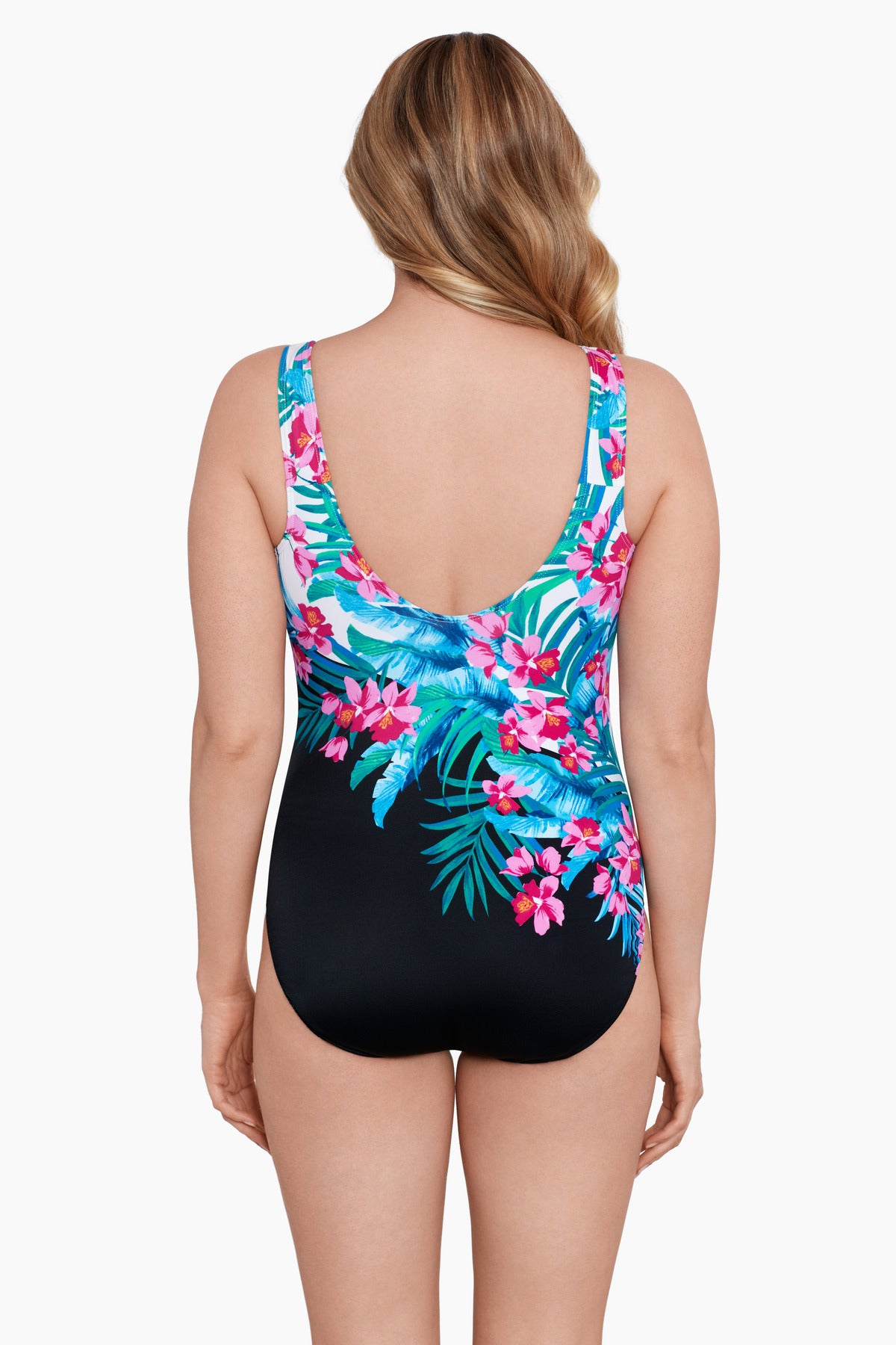 Woman turned away wearing a multicolored floral printed half black and white split one-piece swimsuit