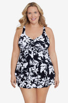 Woman wearing a black and white floral printed bow front swim dress