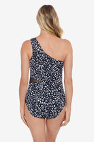 Woman faced away wearing a black and white scaley printed mesh cut out one-piece swimsuit