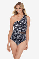 Woman wearing a black and white scaley printed mesh cut out one-piece swimsuit