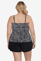 Woman turned away wearing a black and white scaley printed tiered tankini top