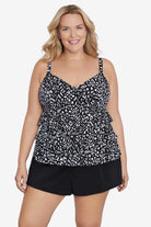 Woman wearing a black and white scaley printed tiered tankini top