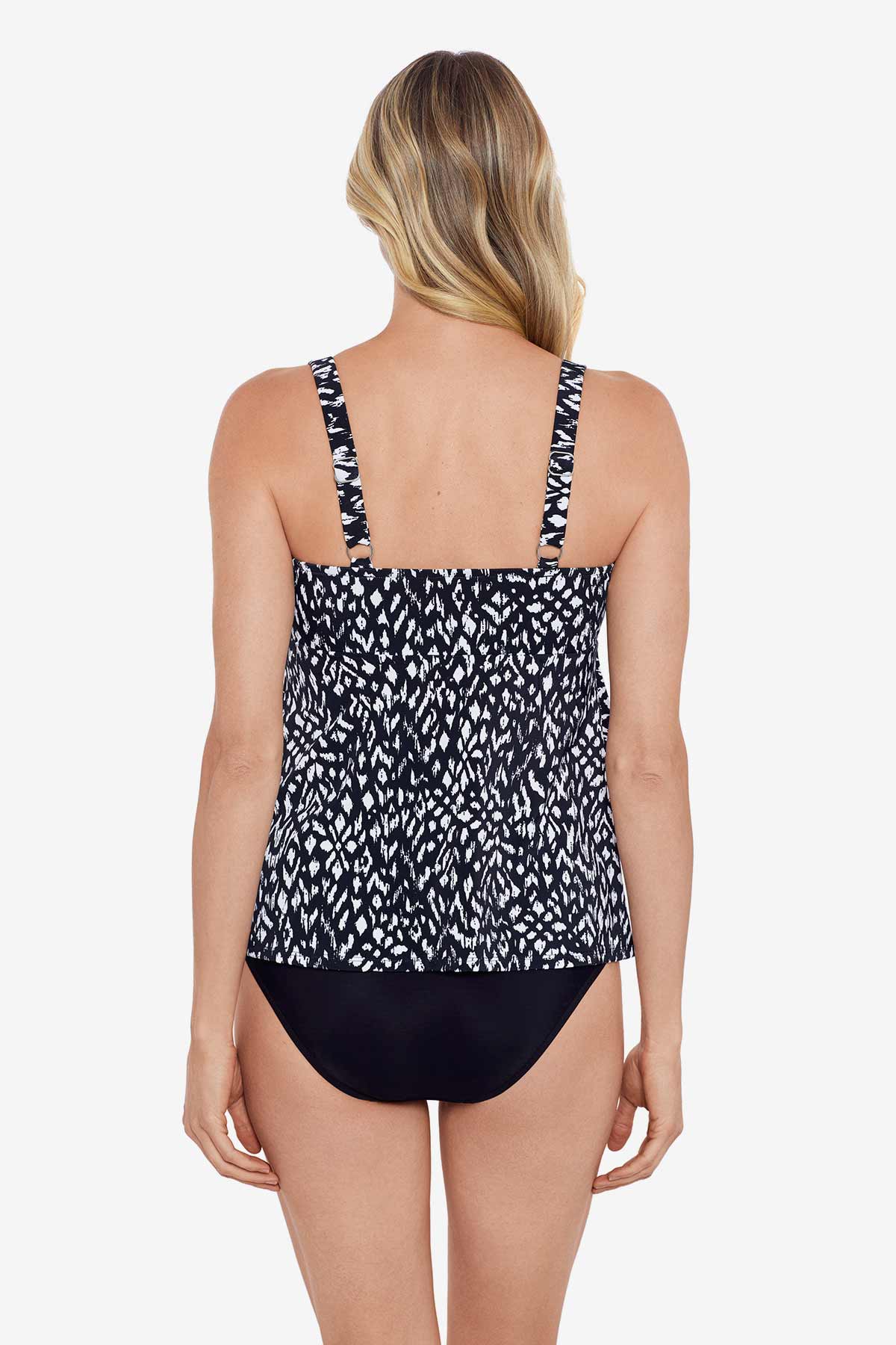 Woman turned away wearing a black and white scaley printed tiered tankini top
