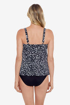 Woman turned away wearing a black and white scaley printed tiered tankini top