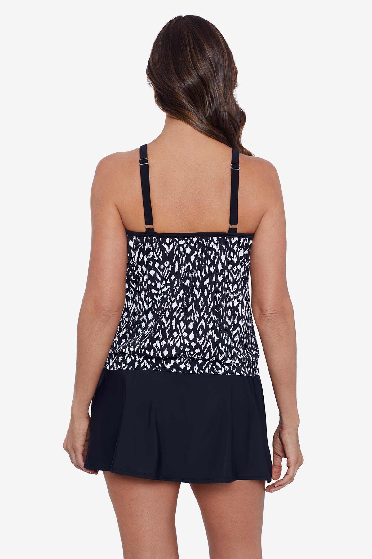 Woman faced away wearing a black and white scaley printed high neck blouson tankini top