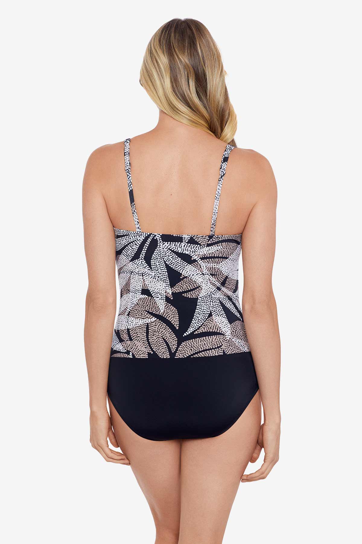 Woman turned away wearing a dotted leaf pattern one-piece swimsuit