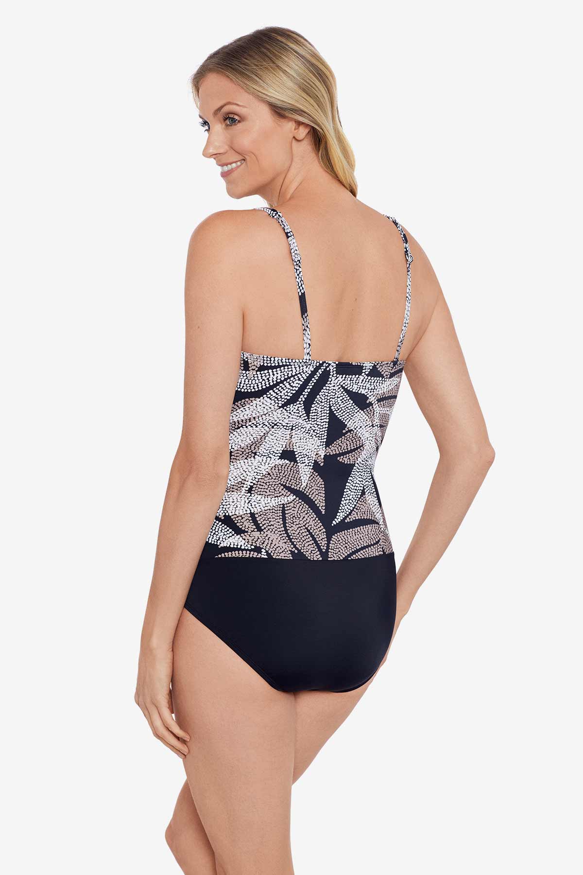 Woman turned left wearing a dotted leaf pattern one-piece swimsuit