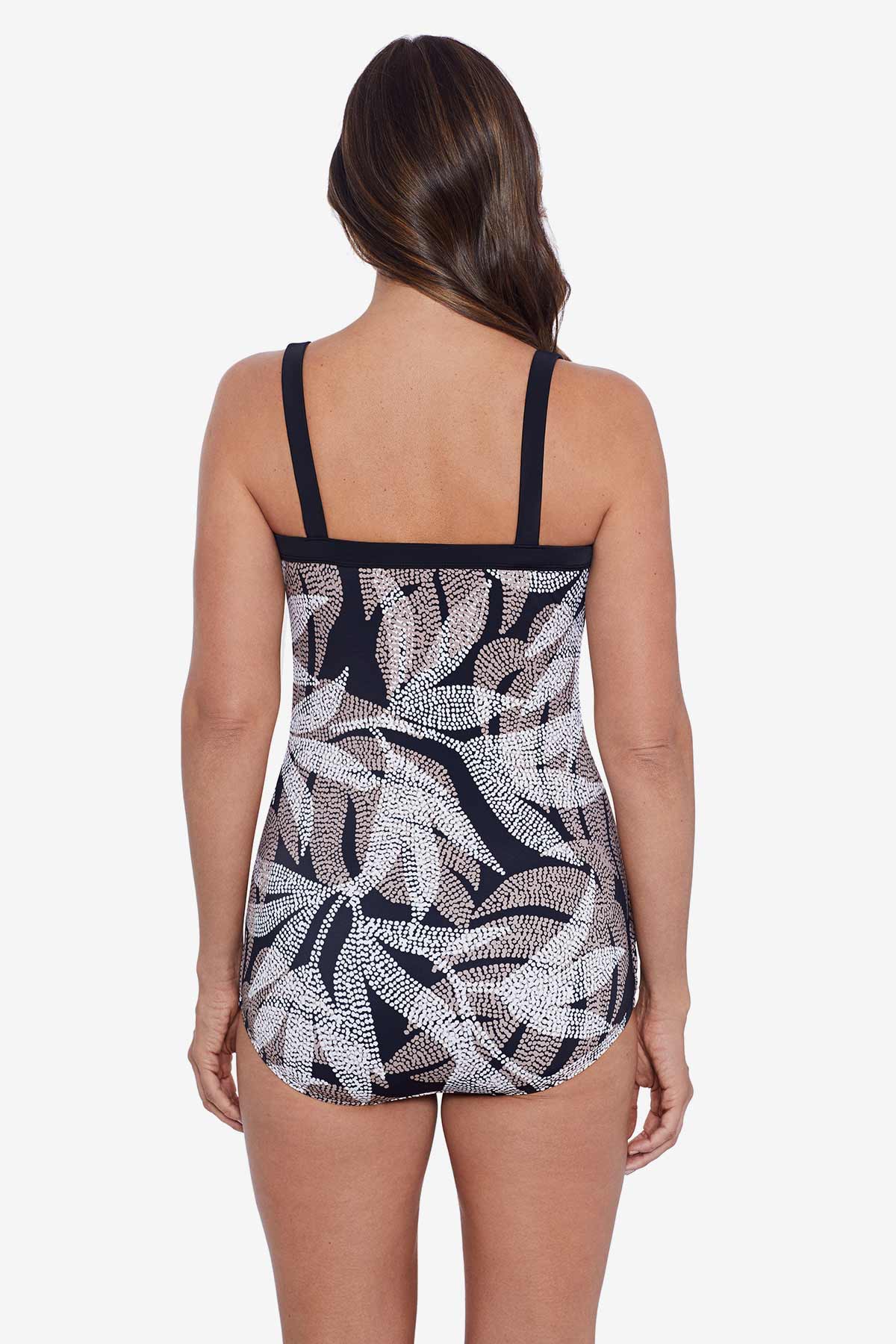 Woman faced away wearing a dotted leaf pattern sarong one-piece swimsuit