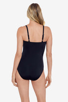 Woman faced away wearing a black one-piece swimsuit