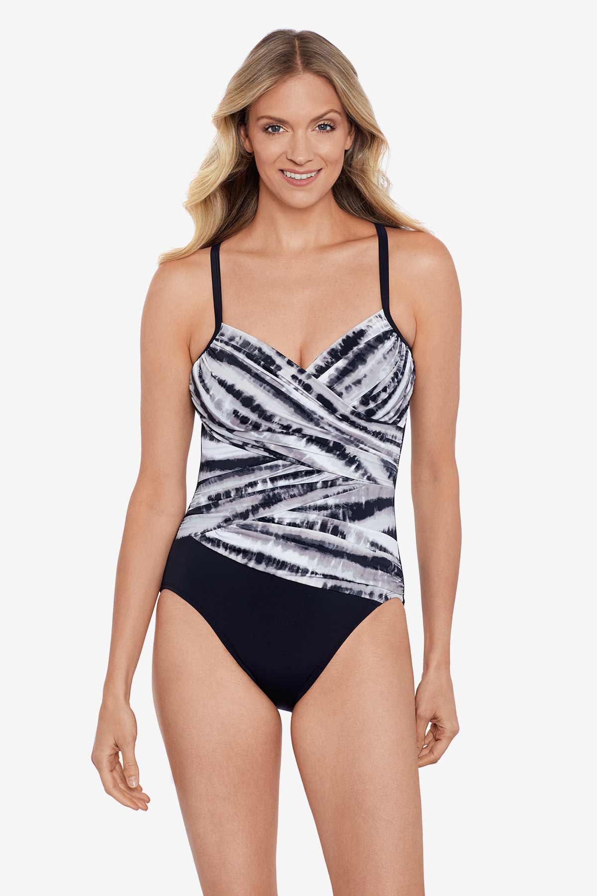 Woman wearing a black and white tie dye one-piece swimsuit
