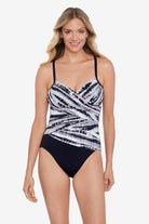 Woman wearing a black and white tie dye one-piece swimsuit