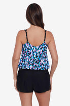 Woman turned away wearing a multicolored abstract printed blouson tankini top