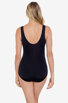 Woman faced away wearing a one-piece swimsuit