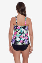 Woman faced away wearing a multicolored tropical printed ruffle tiered tankini top