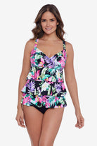 Woman wearing a multicolored tropical printed ruffle tiered tankini top