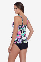Woman faced left wearing a multicolored tropical printed ruffle tiered tankini top