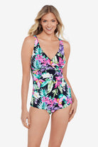 Woman wearing a multicolored tropical printed one-piece swimsuit