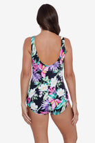 Woman faced away wearing a floral printed one-piece swimsuit
