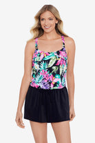 Woman wearing a multicolored tropical printed romper swimsuit