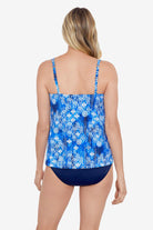 Woman faced away wearing a blue and white abstract pattern flowy tankini top