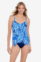 Woman wearing a blue and white abstract pattern flowy tankini top