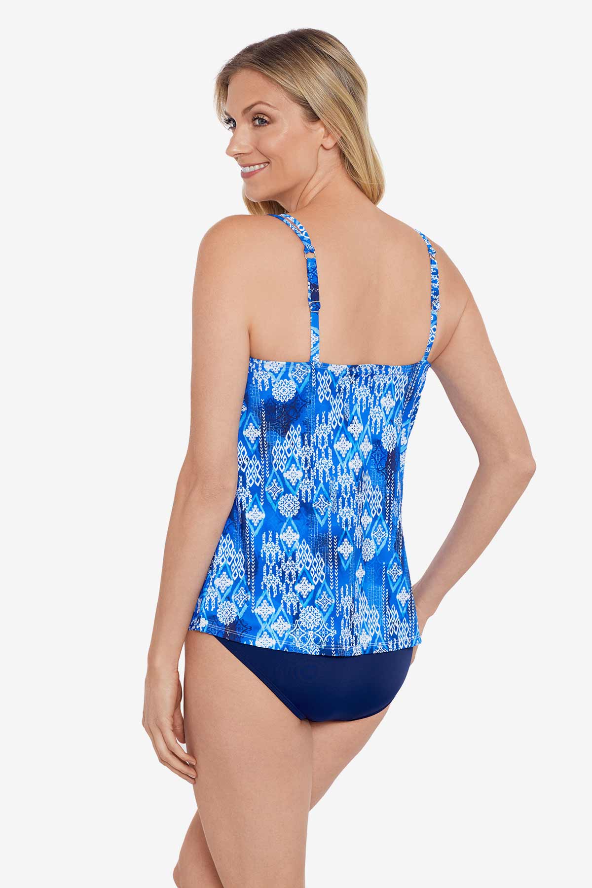 Woman turned left wearing a blue and white abstract pattern flowy tankini top