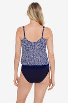 Woman faced away wearing a blue and white abstract pattern blouson tankini top
