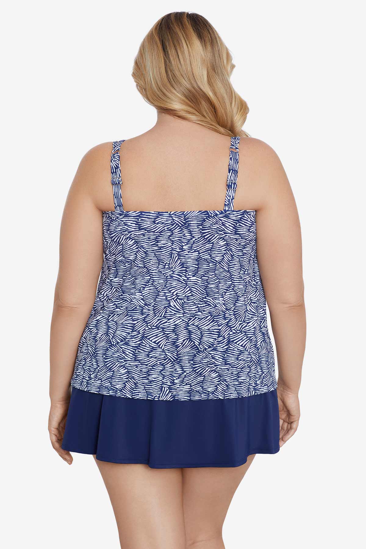 Woman turned away wearing a blue and white abstract pattern tankini top