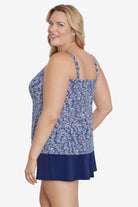 Woman turned left wearing a blue and white abstract pattern tankini top