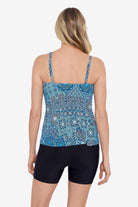 Woman faced away wearing a blue tile pattern side ring tankini top