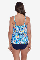 Woman faced away wearing a multicolored small floral printed tankini top