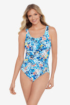 Woman wearing a multicolored floral printed one-piece swimsuit