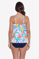 Woman faced away wearing a multicolored tropical print tankini top